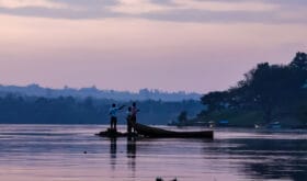 Fisherman on the river Nile at sunset
